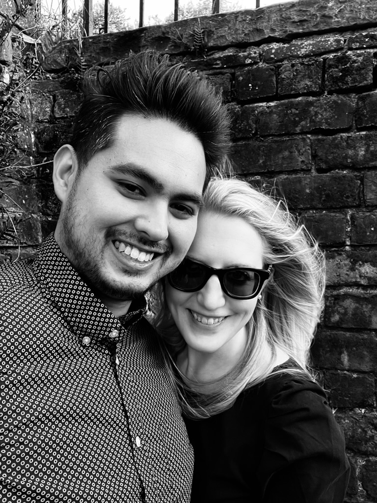 Black and white portrait against a brick wall